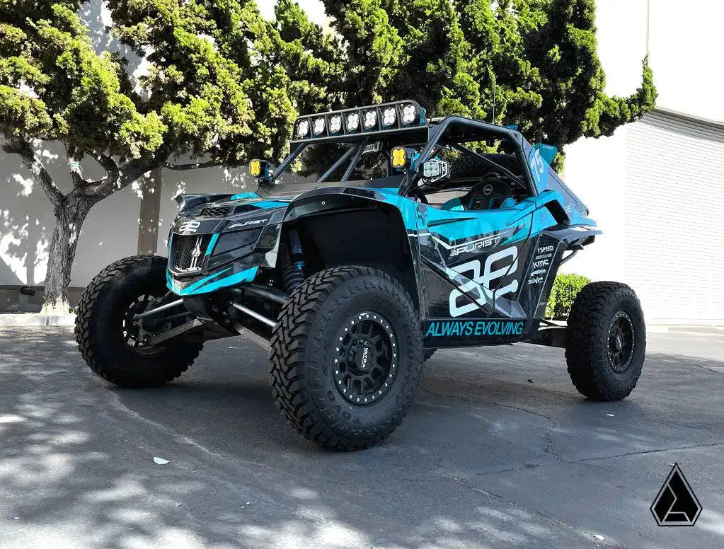 Off-road vehicle with a blue and black design on a paved surface.