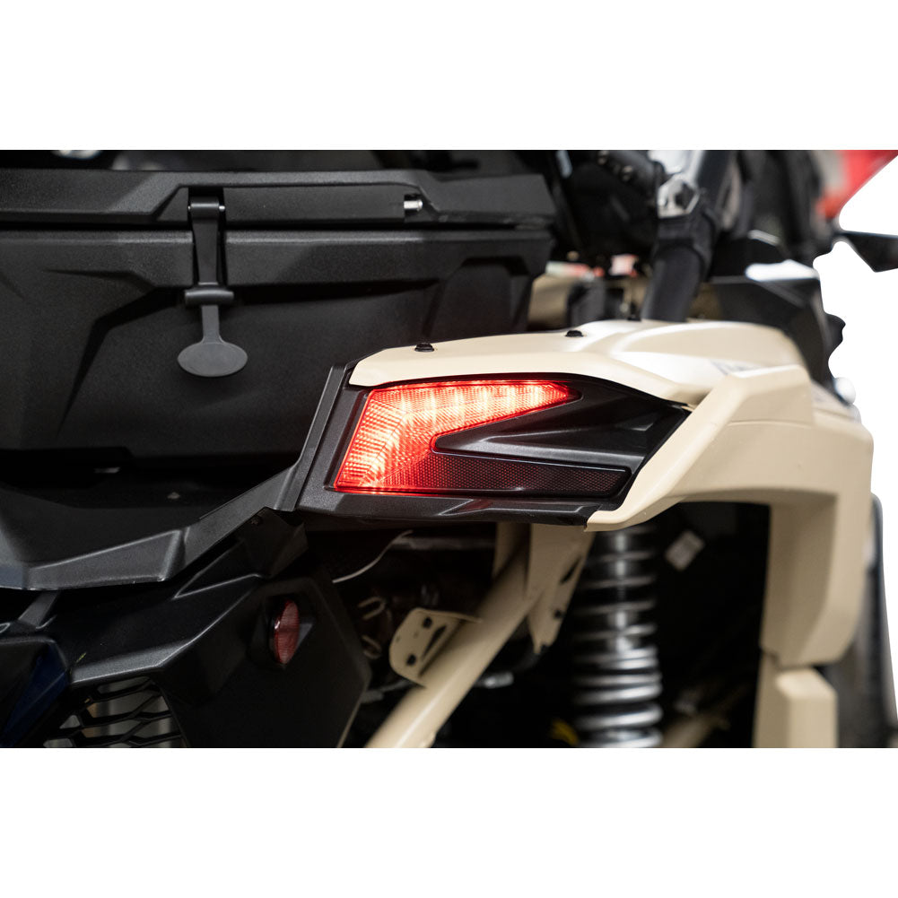 Close-up of a motorcycle's taillight and rear section on a white background