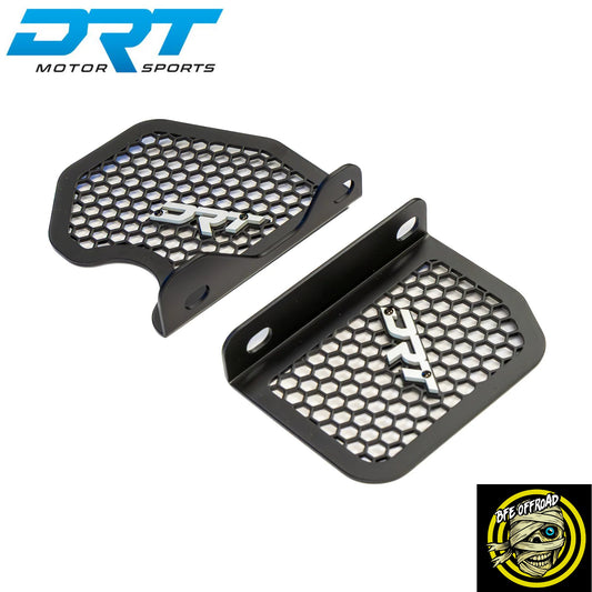 Two black motorcycle fuel tank guards with honeycomb mesh grilles and silver DRT logo emblems, shown on a white background with DRT Motor Sports and BFE Offroad branding.