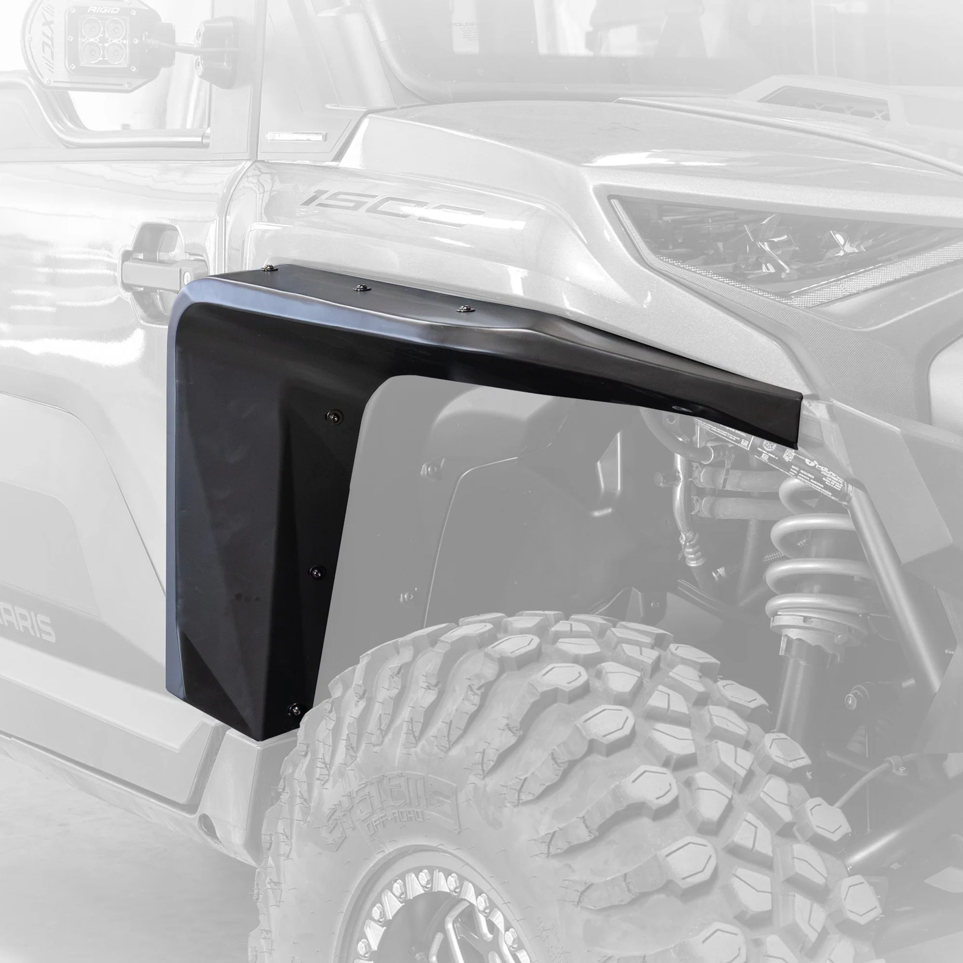 A black aluminum fender liner installed on the front wheel well of a white off-road vehicle, shown against a faded background of the same vehicle.