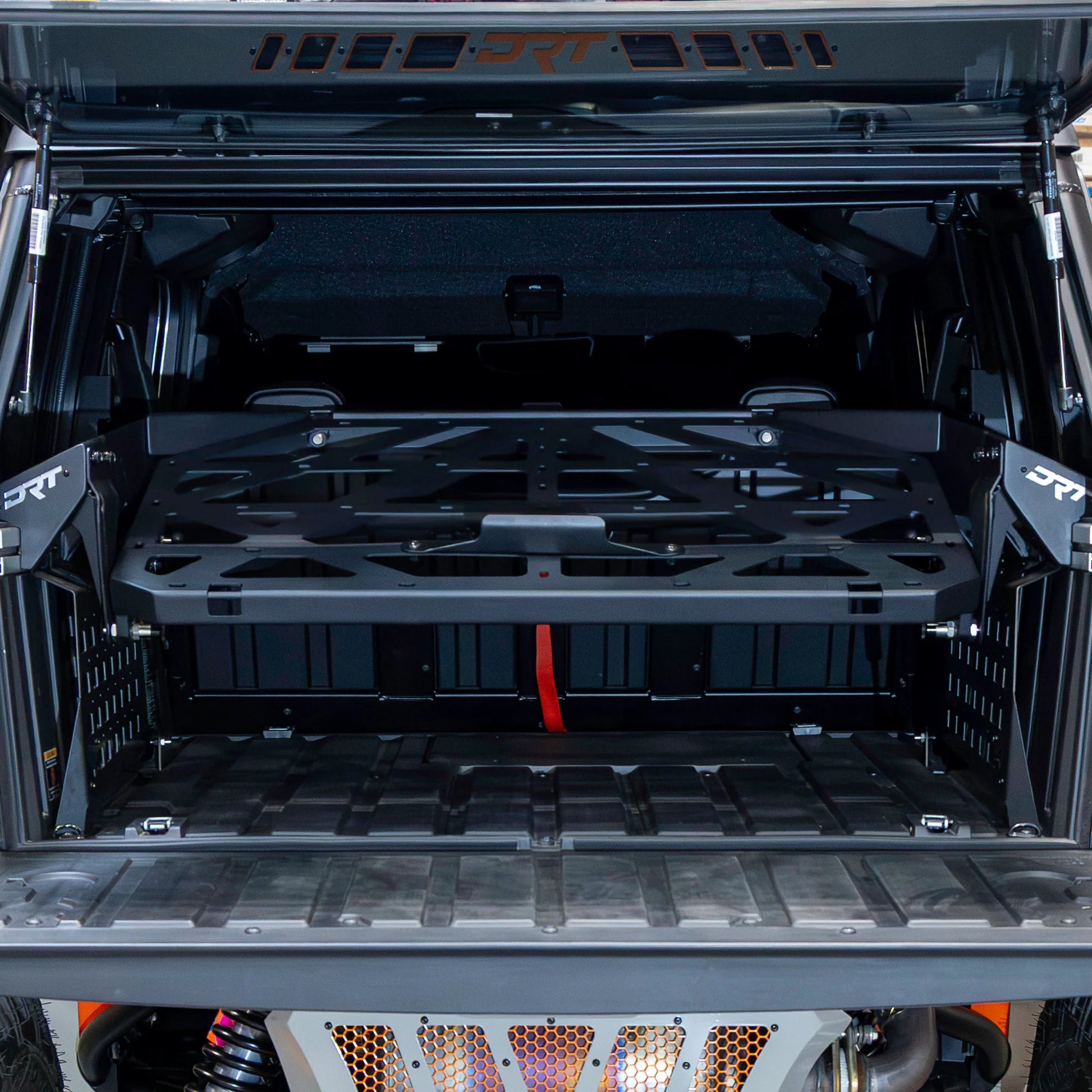 Open cargo area of a vehicle with a black storage rack.