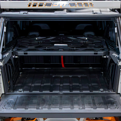 Open cargo area of a vehicle with a black storage tray