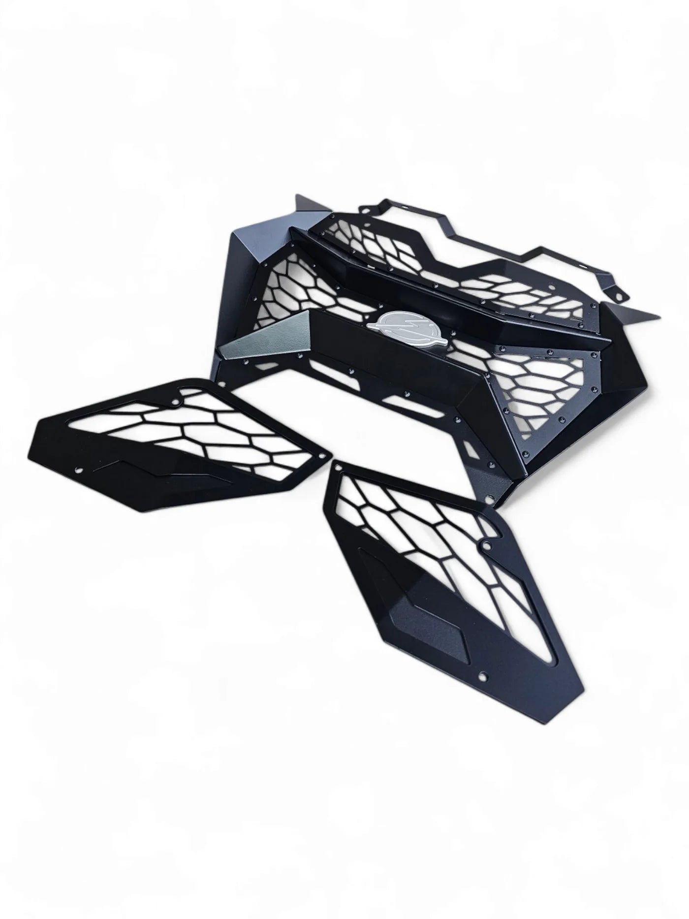 Black metal grille with honeycomb design on a white background