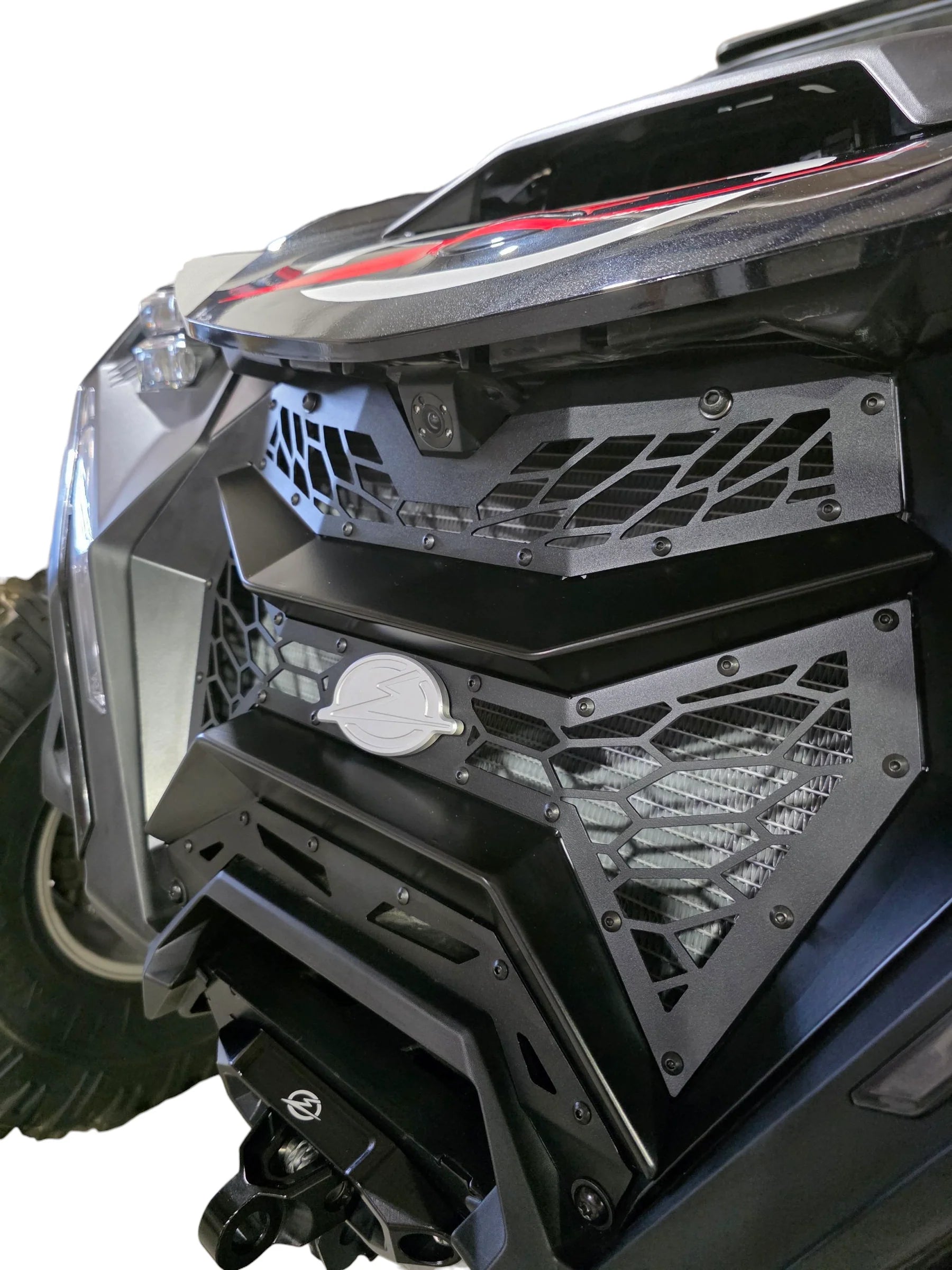 Close-up of a vehicle's front bumper with a detailed grille design on a white background