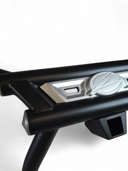 Close-up of a black metal frame with a silver emblem on a white background