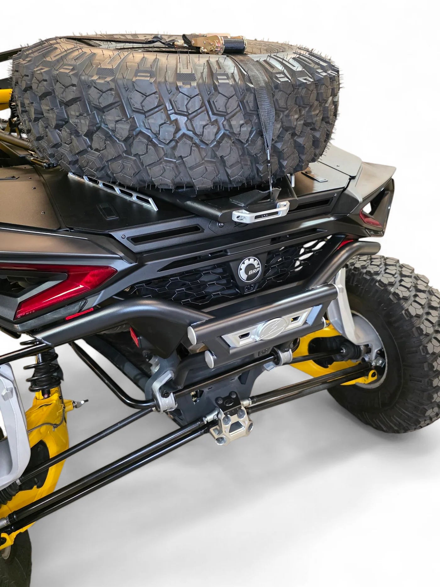 Close-up of a four-wheeler with a spare tire on a white background