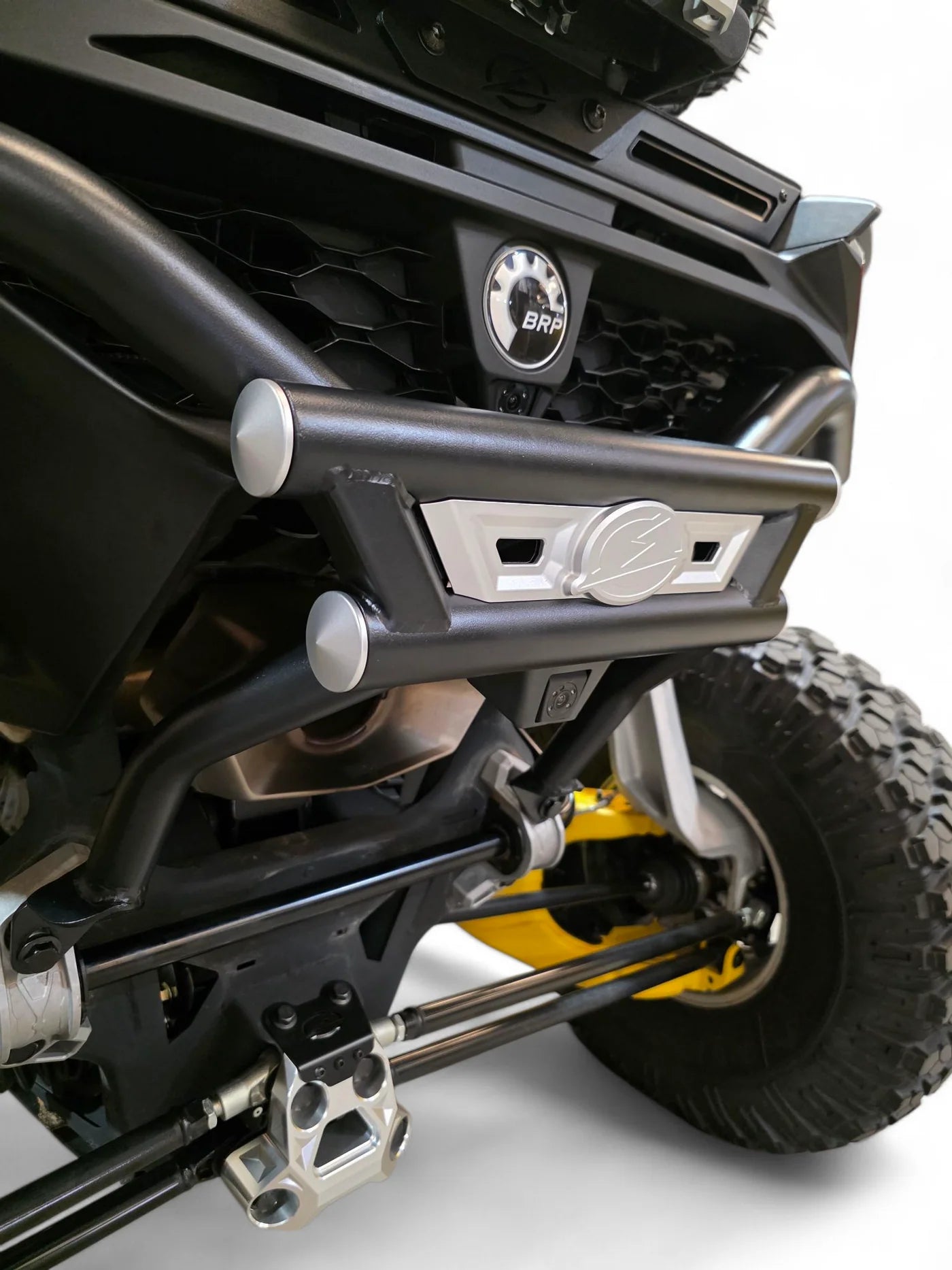 Close-up of a vehicle's front bumper and suspension system on a white background