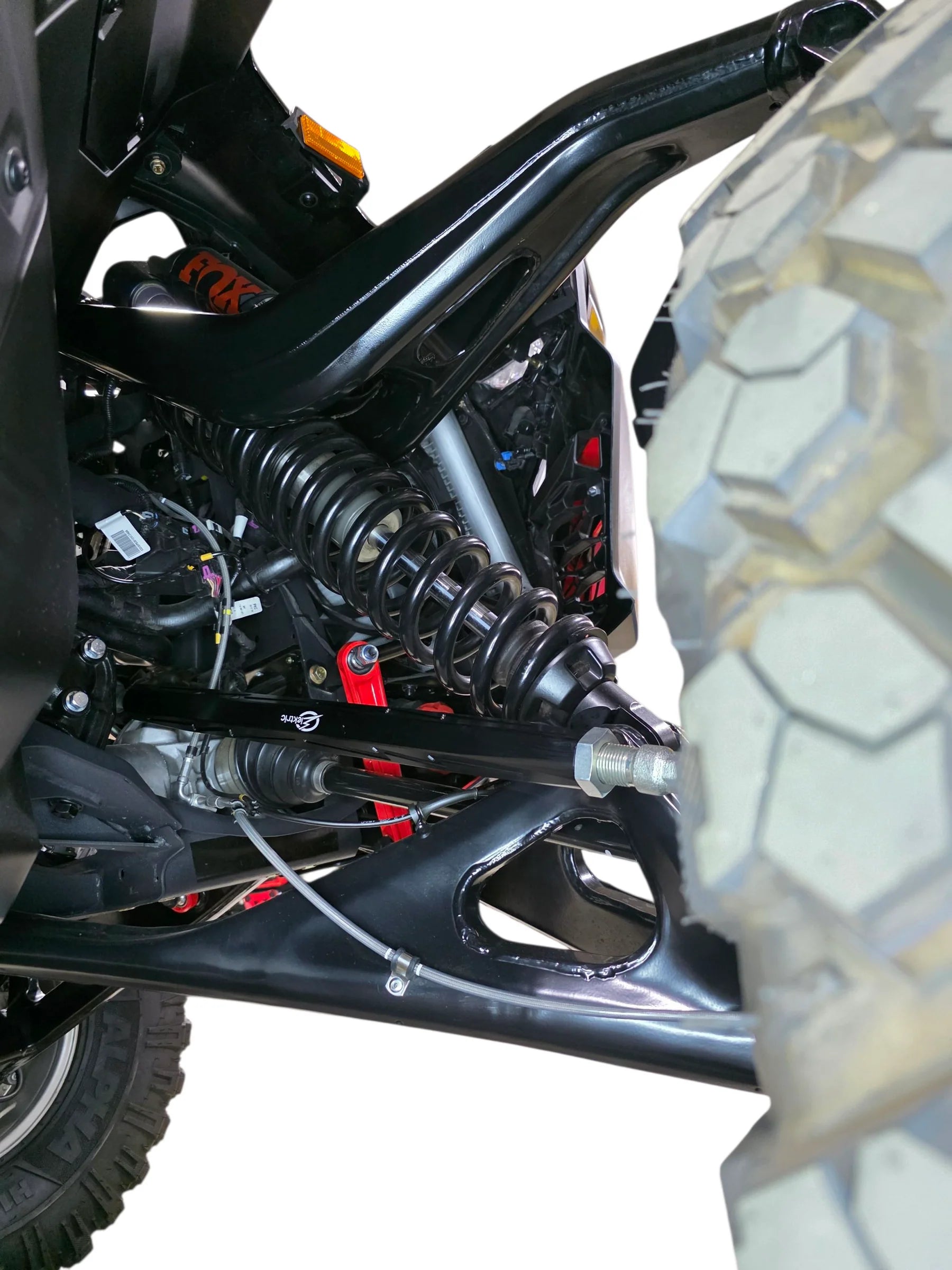 Close-up of a vehicle suspension system with a focus on the coil spring and shock absorber.