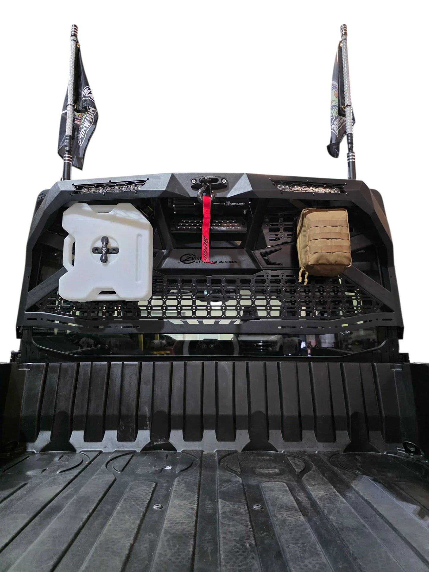 Back of a truck bed with storage compartments and equipment on a white background
