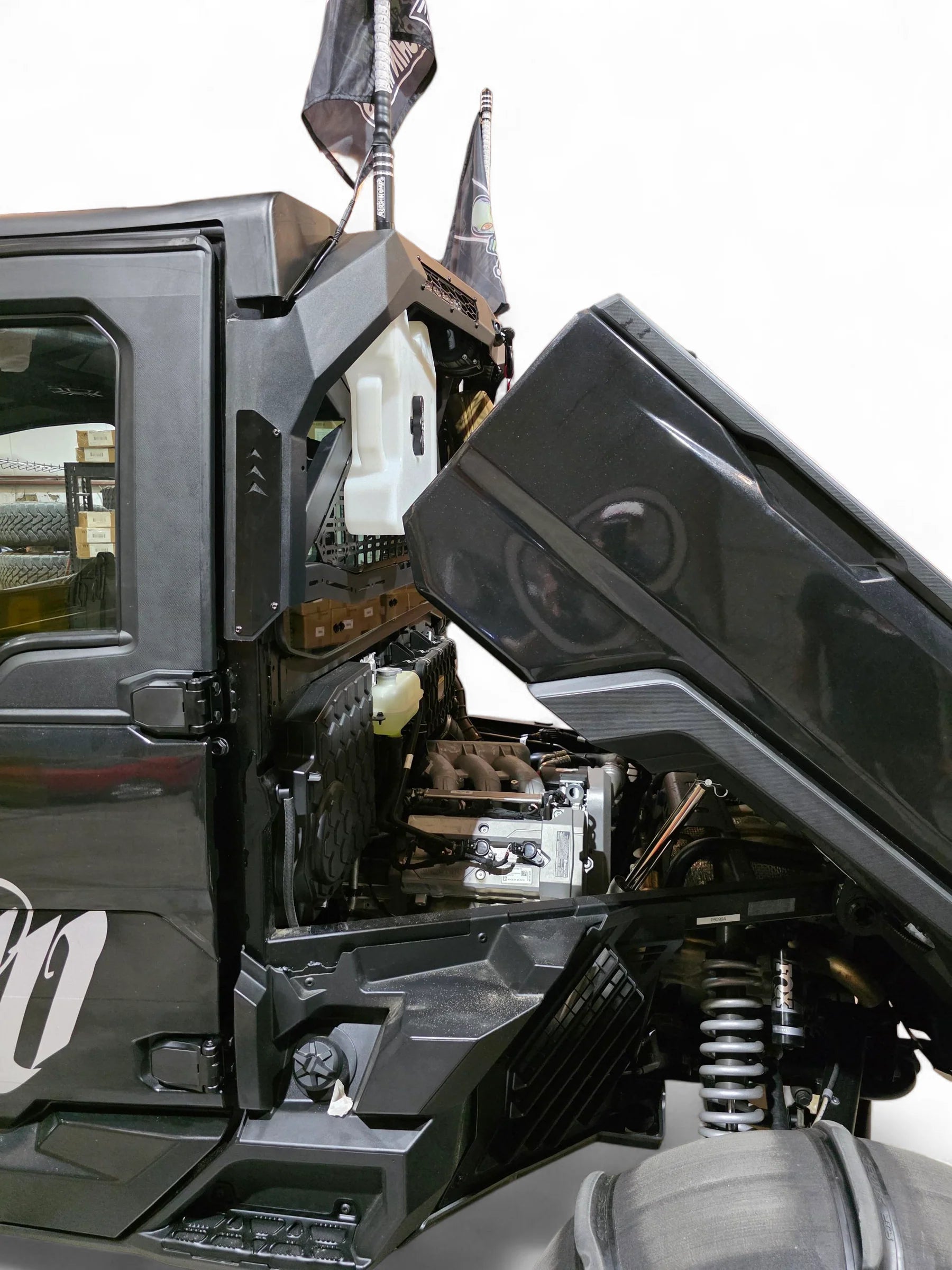 Close-up of a black off-road vehicle with open door and detailed interior.