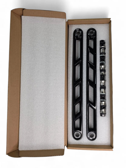 Set of black metal brackets in a cardboard box on a white background