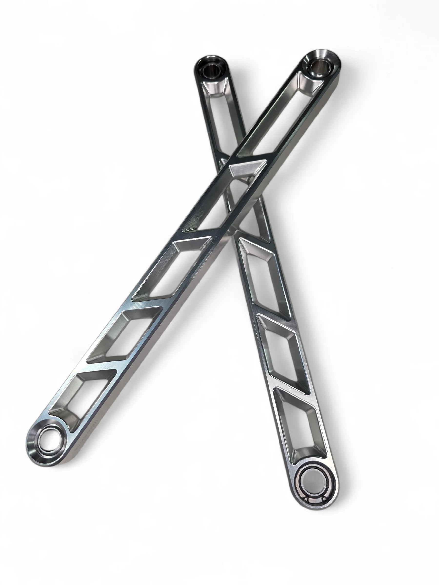 Two crossed metal wrenches on a white background