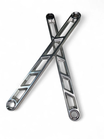 Two crossed metal wrenches on a white background