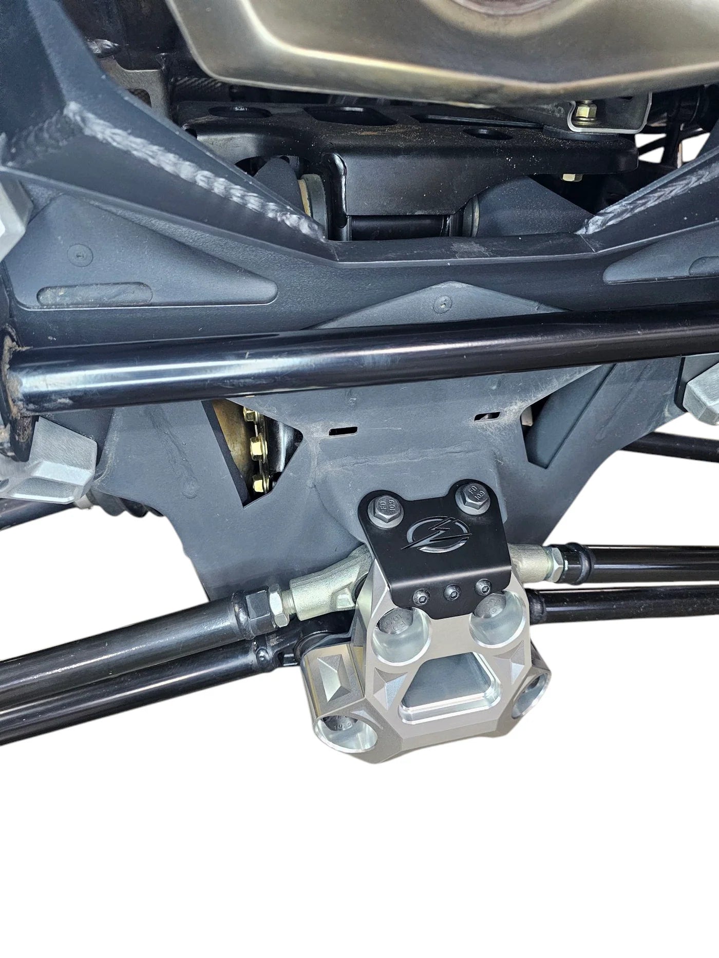 Close-up of a mechanical component on a vehicle, likely a part of the suspension system.