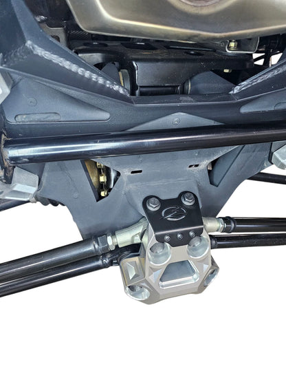 Close-up of a mechanical component on a vehicle, likely a part of the suspension system.