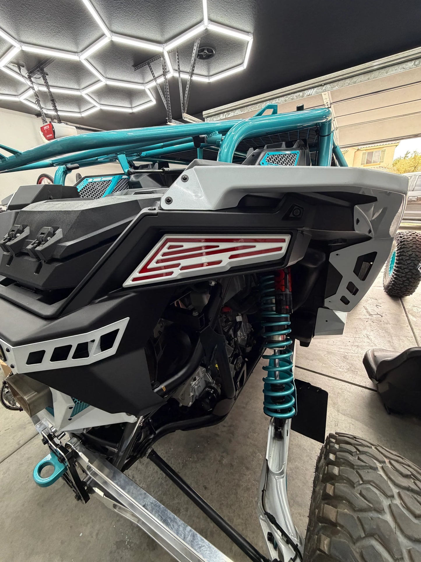 Close-up of a snowmobile with visible branding in a garage setting