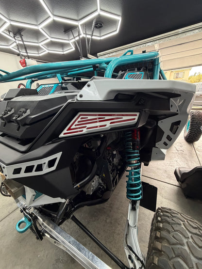 Close-up of a snowmobile with visible branding in a garage setting