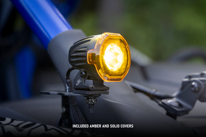 Stinger LED pod light with amber cover mounted on vehicle frame