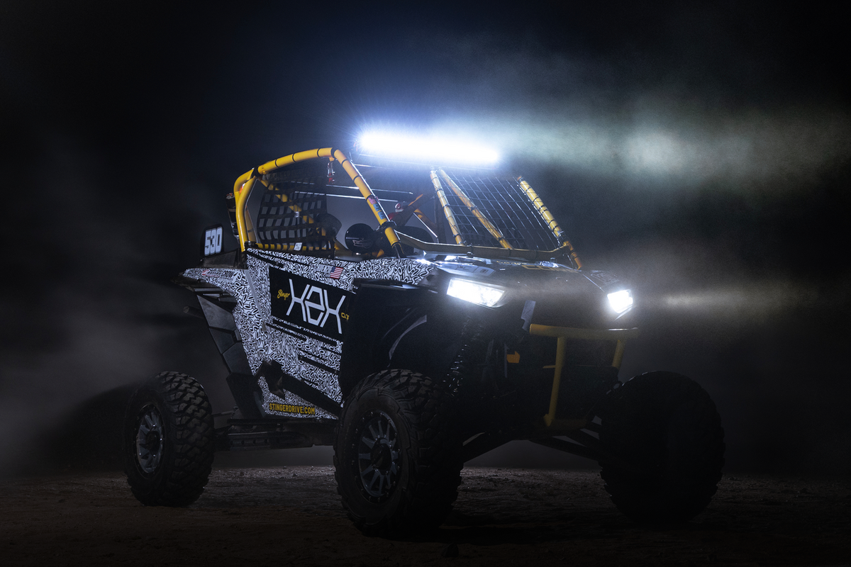 Stinger off road vehicle with bright LED light bar illuminated at night