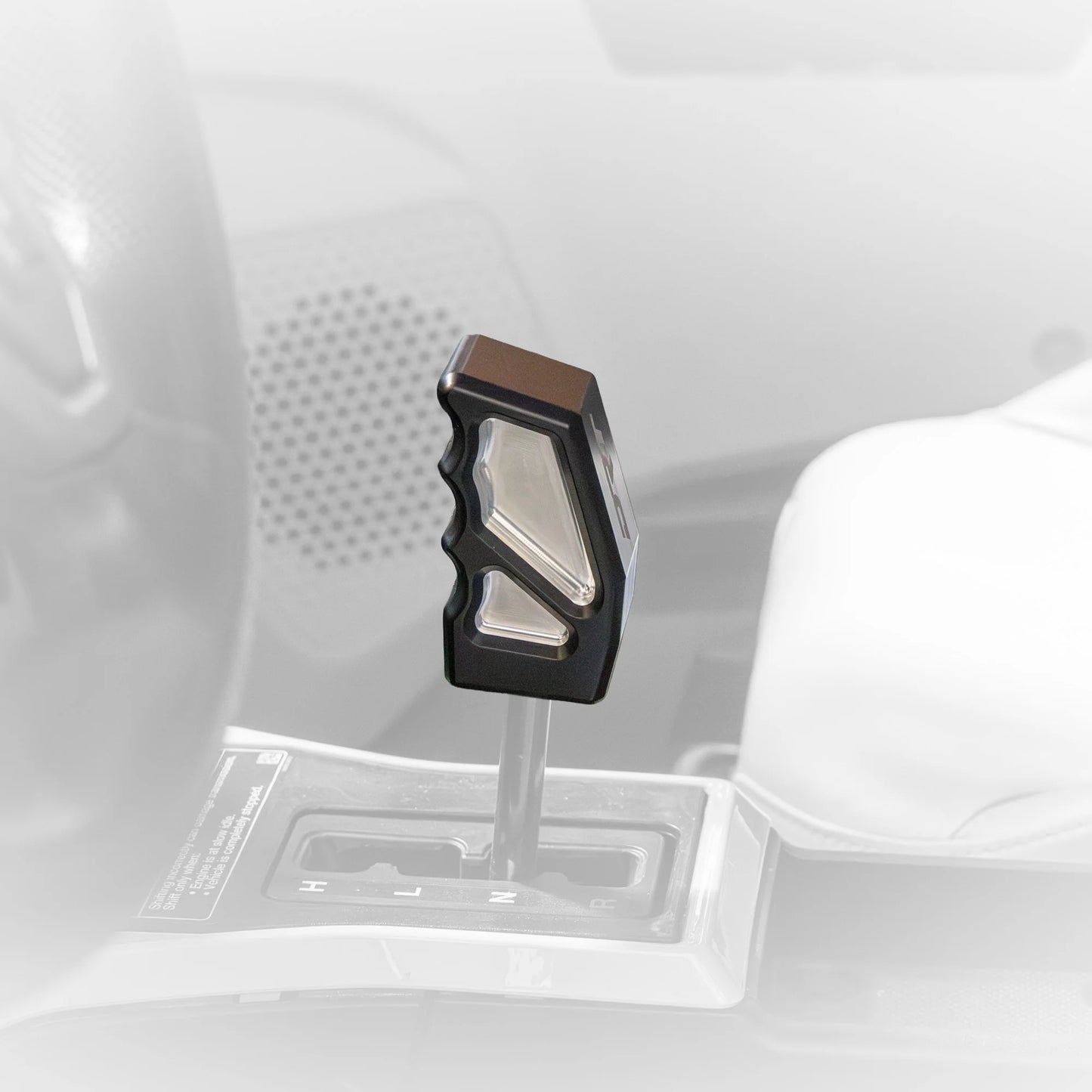 Car gear shift lever with a black and silver design on a white background
