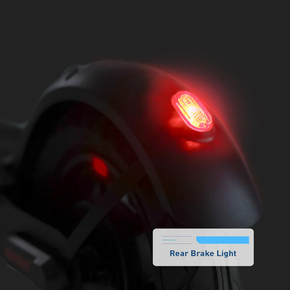 Red rear brake light on a dark background