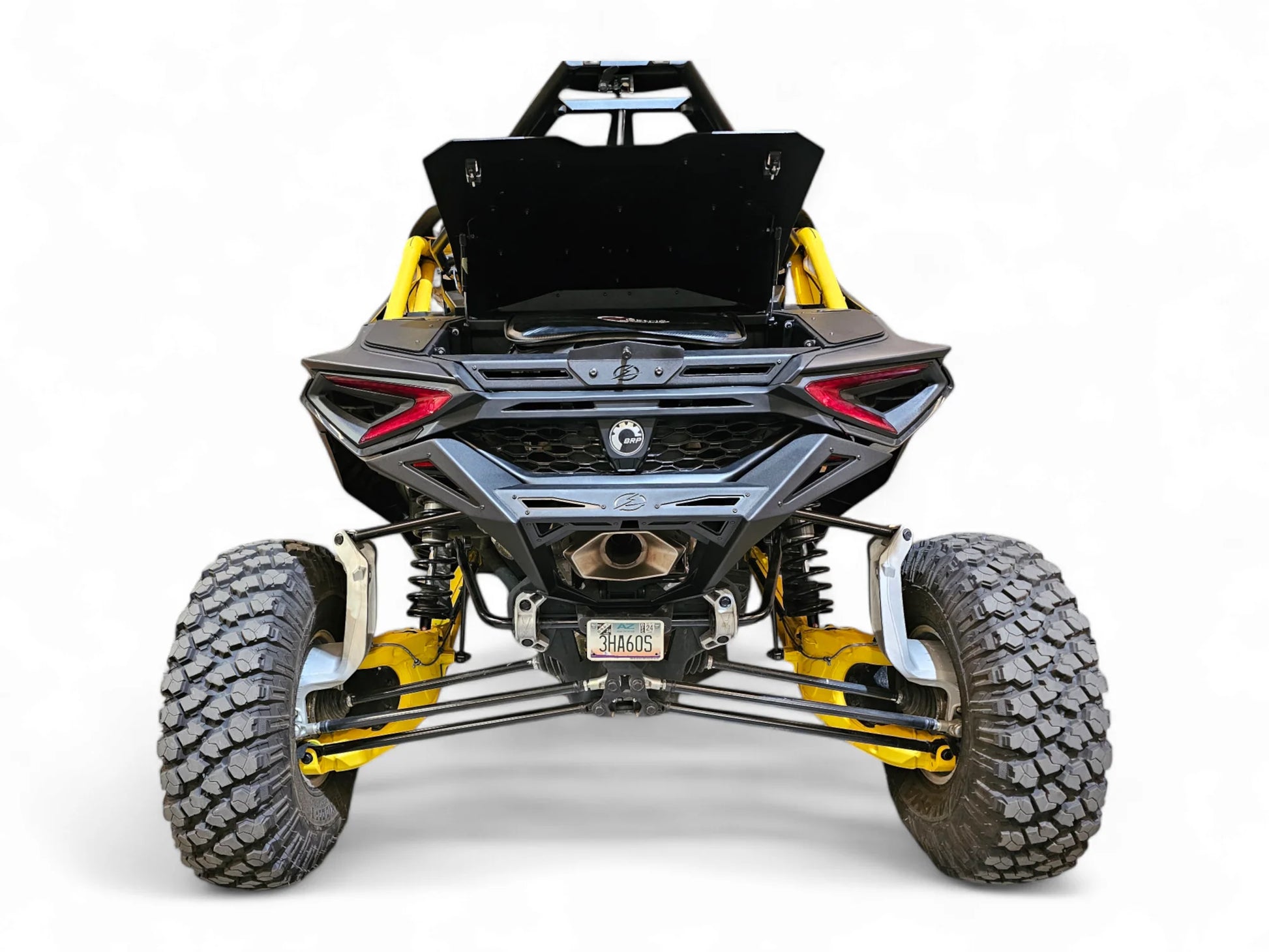 Side view of a black and yellow off-road vehicle on a white background
