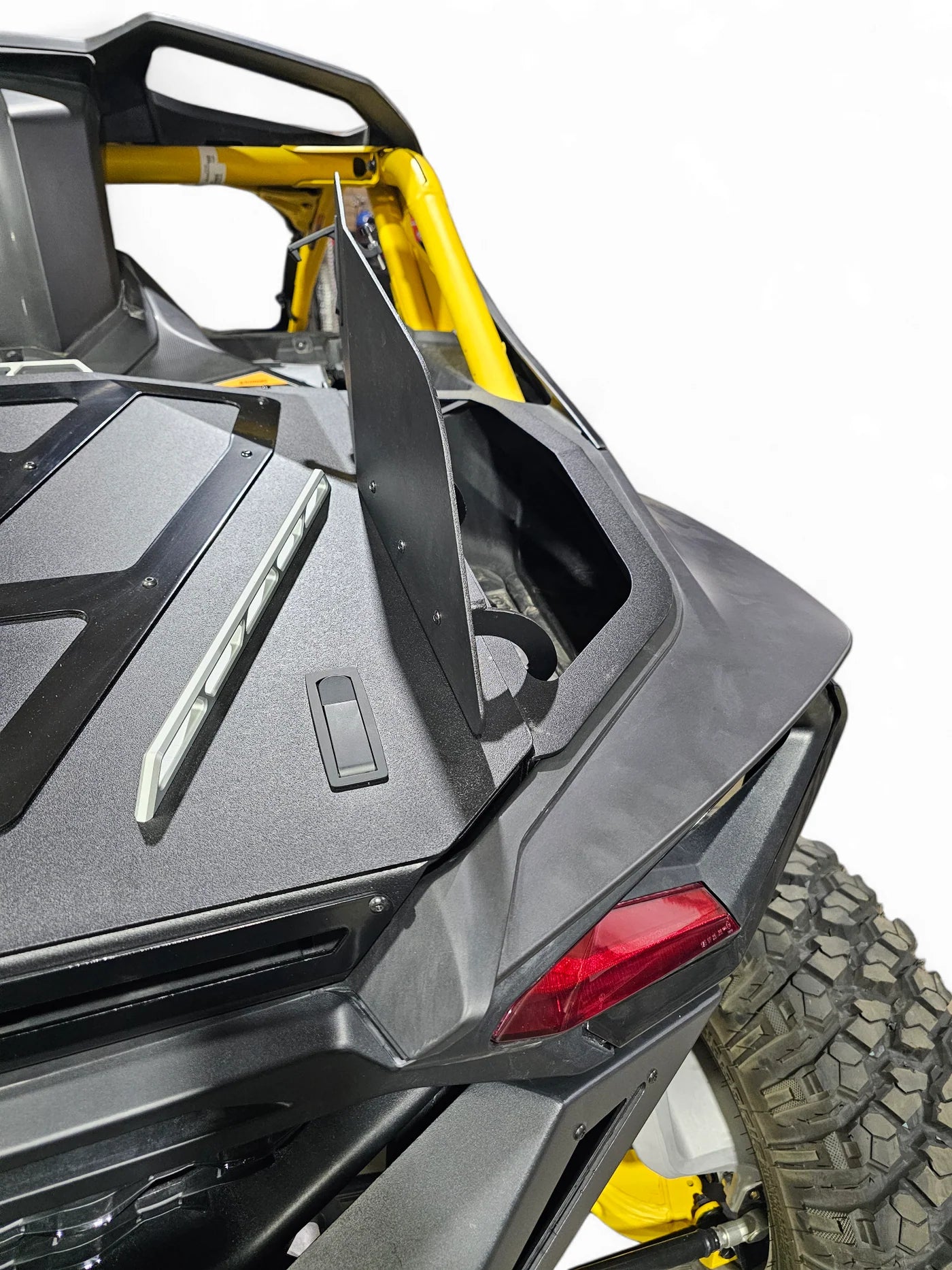 Close-up of a black and yellow off-road vehicle with a focus on the rear design.