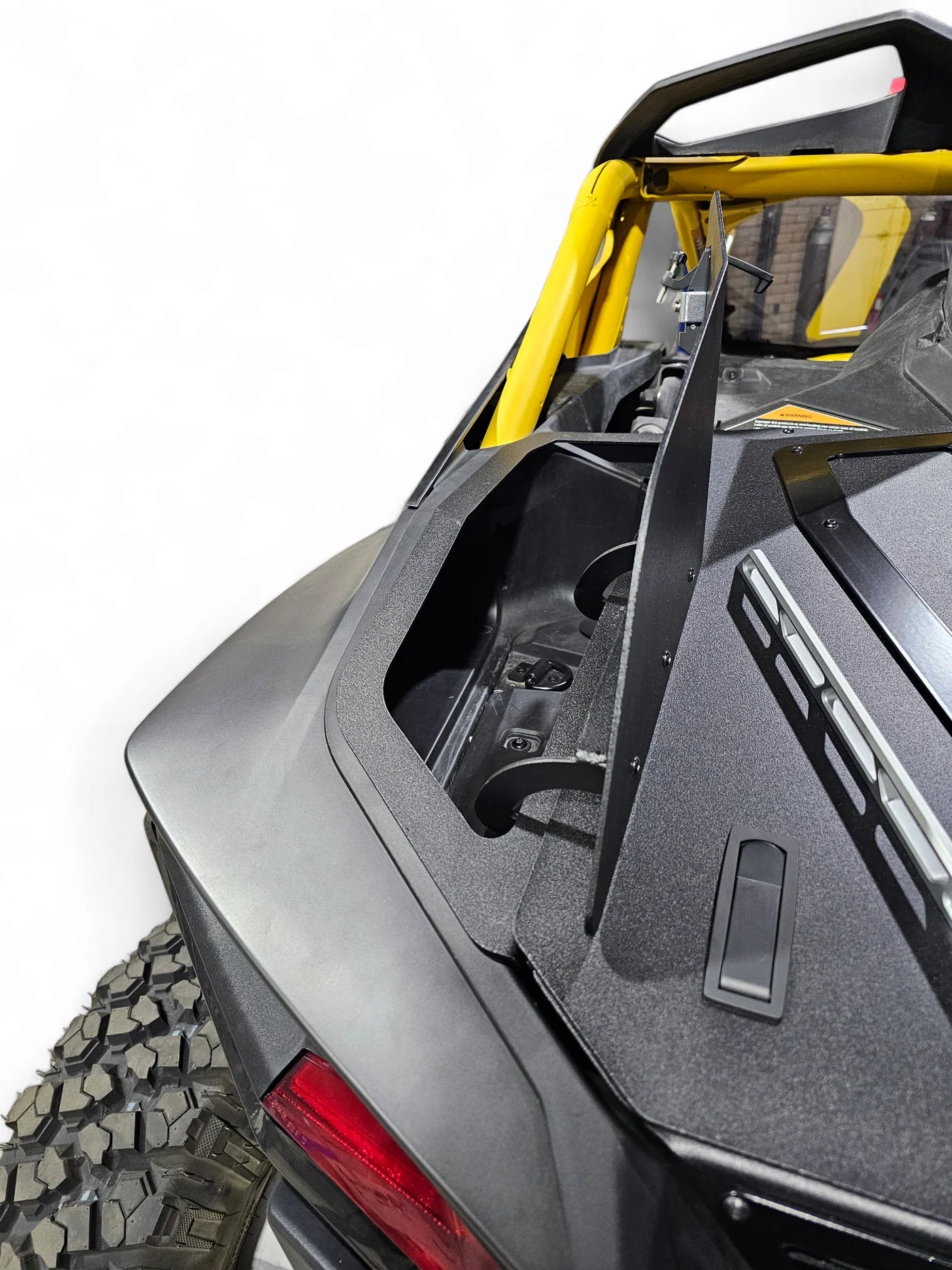 Close-up of a side view of an off-road vehicle with a yellow frame.