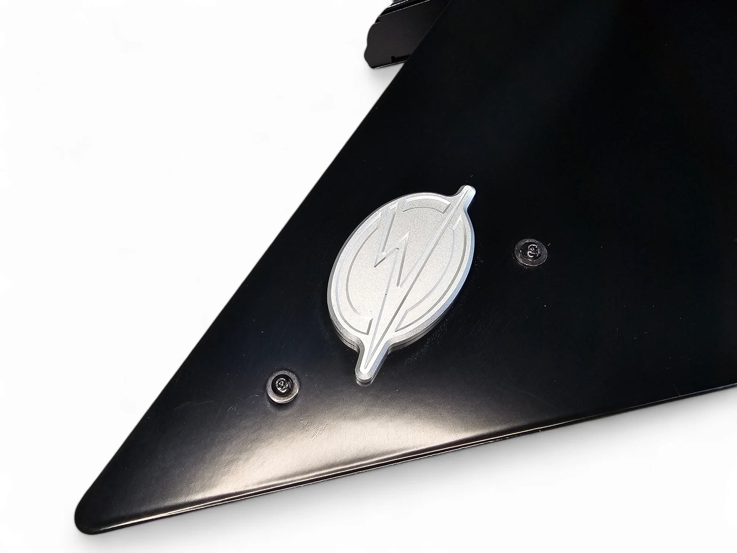 Black car fender with a silver logo on a white background