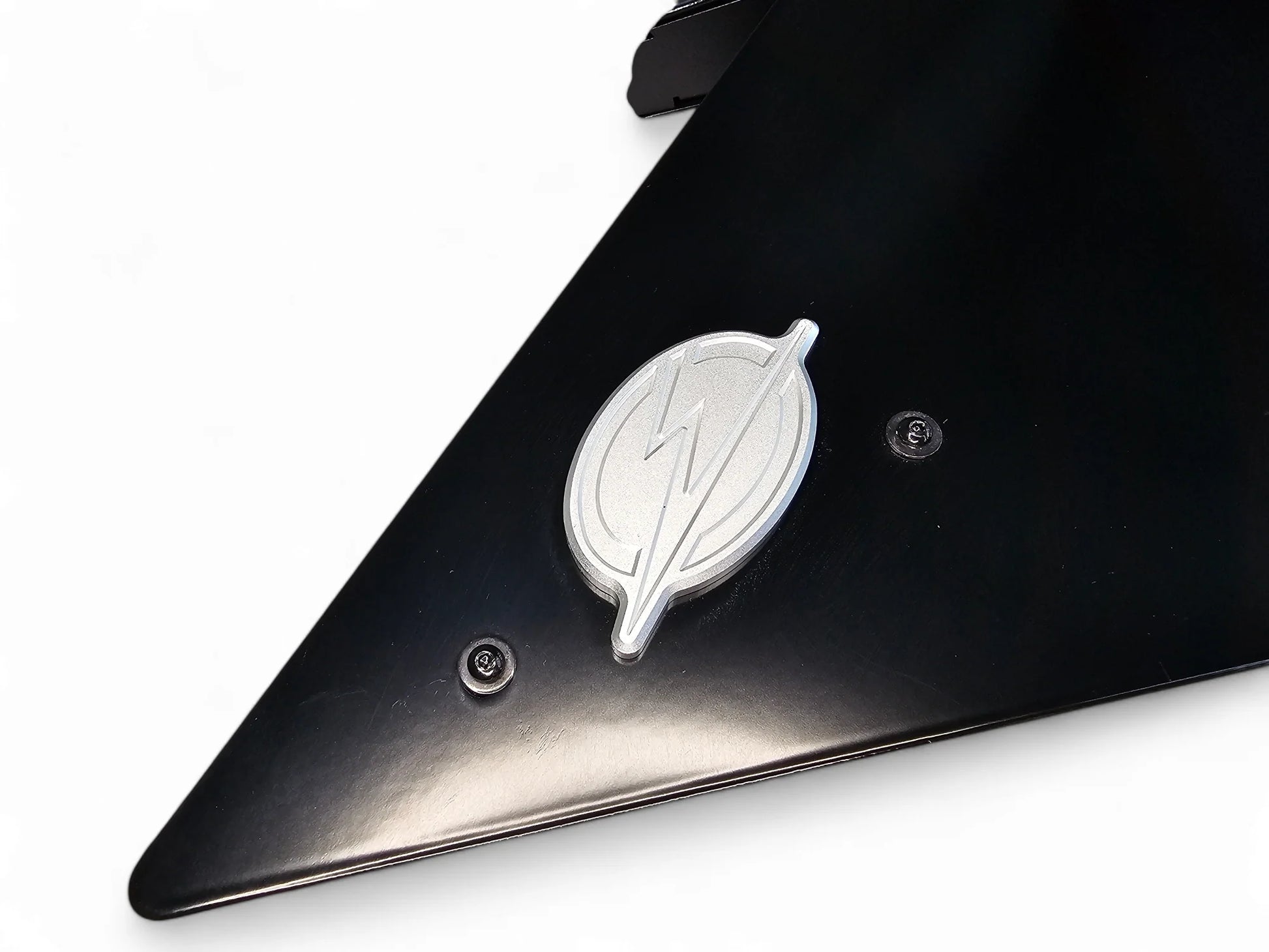 Black car fender with a silver logo on a white background