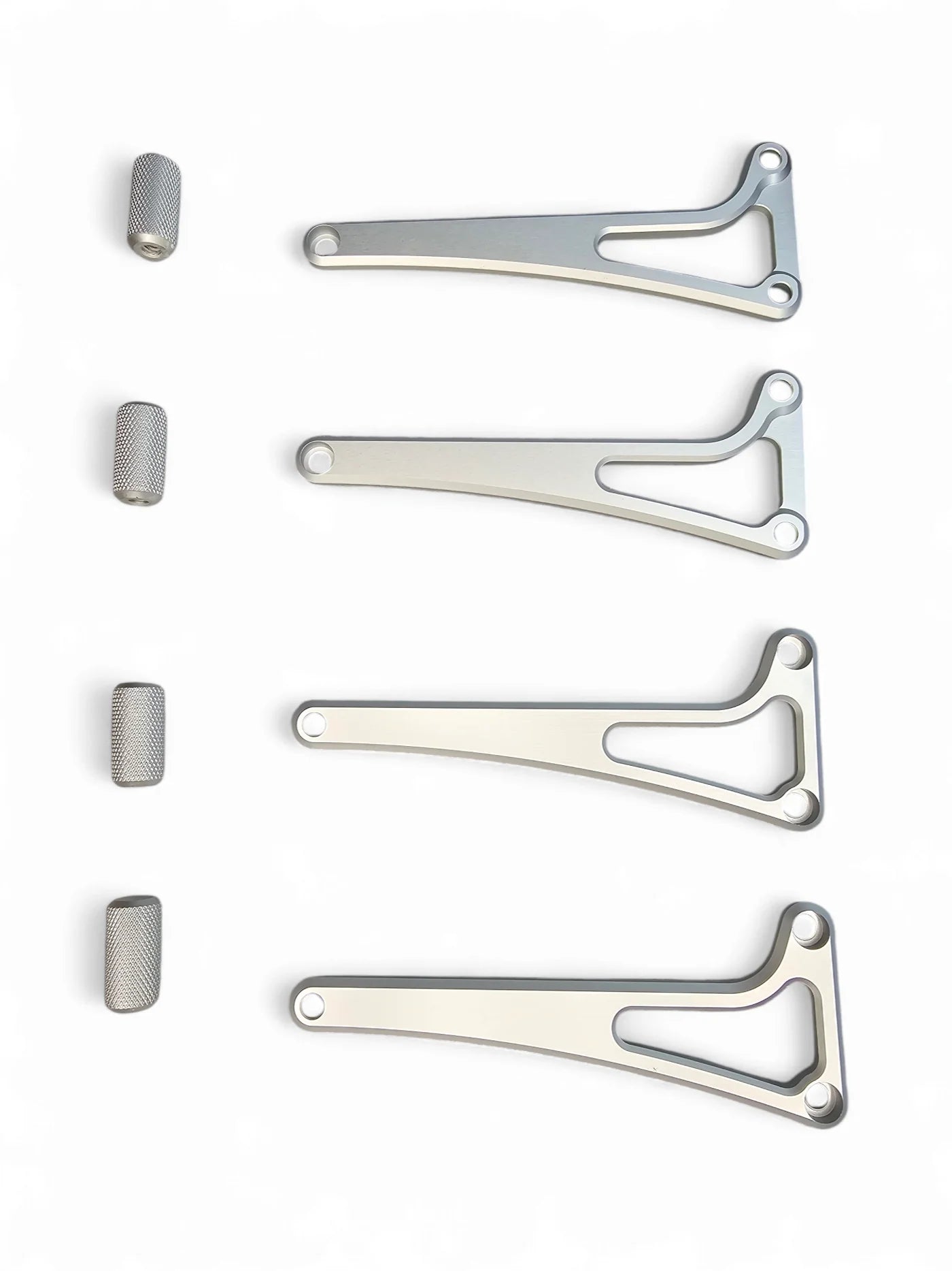 Set of metal brackets and cylindrical components on a white background