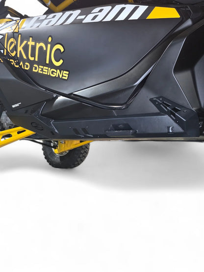 Close-up of a black and yellow vehicle with 'Can-Am' and 'ektric' branding on a white background.