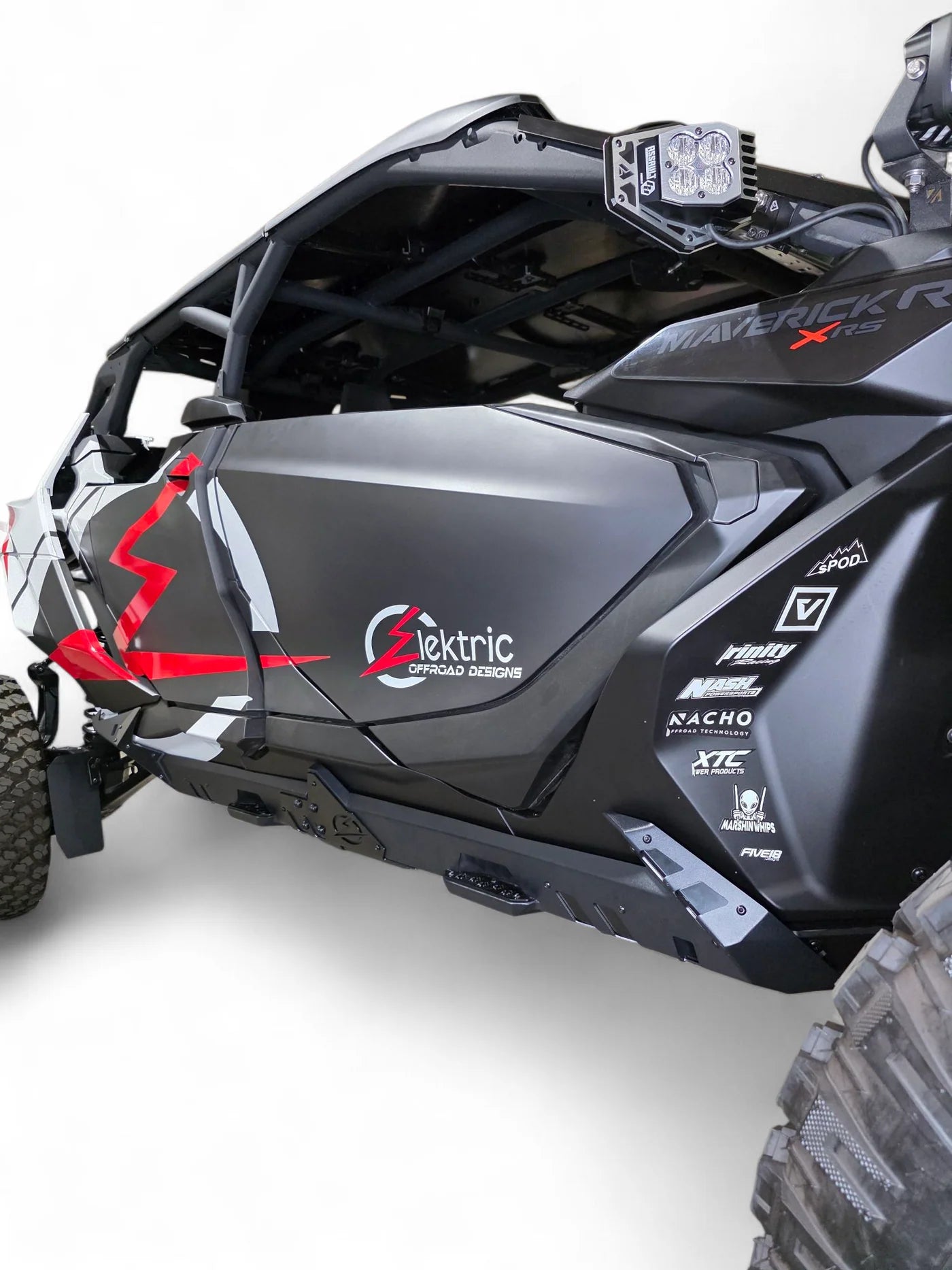 Side view of a black and gray off-road vehicle with branding on a white background