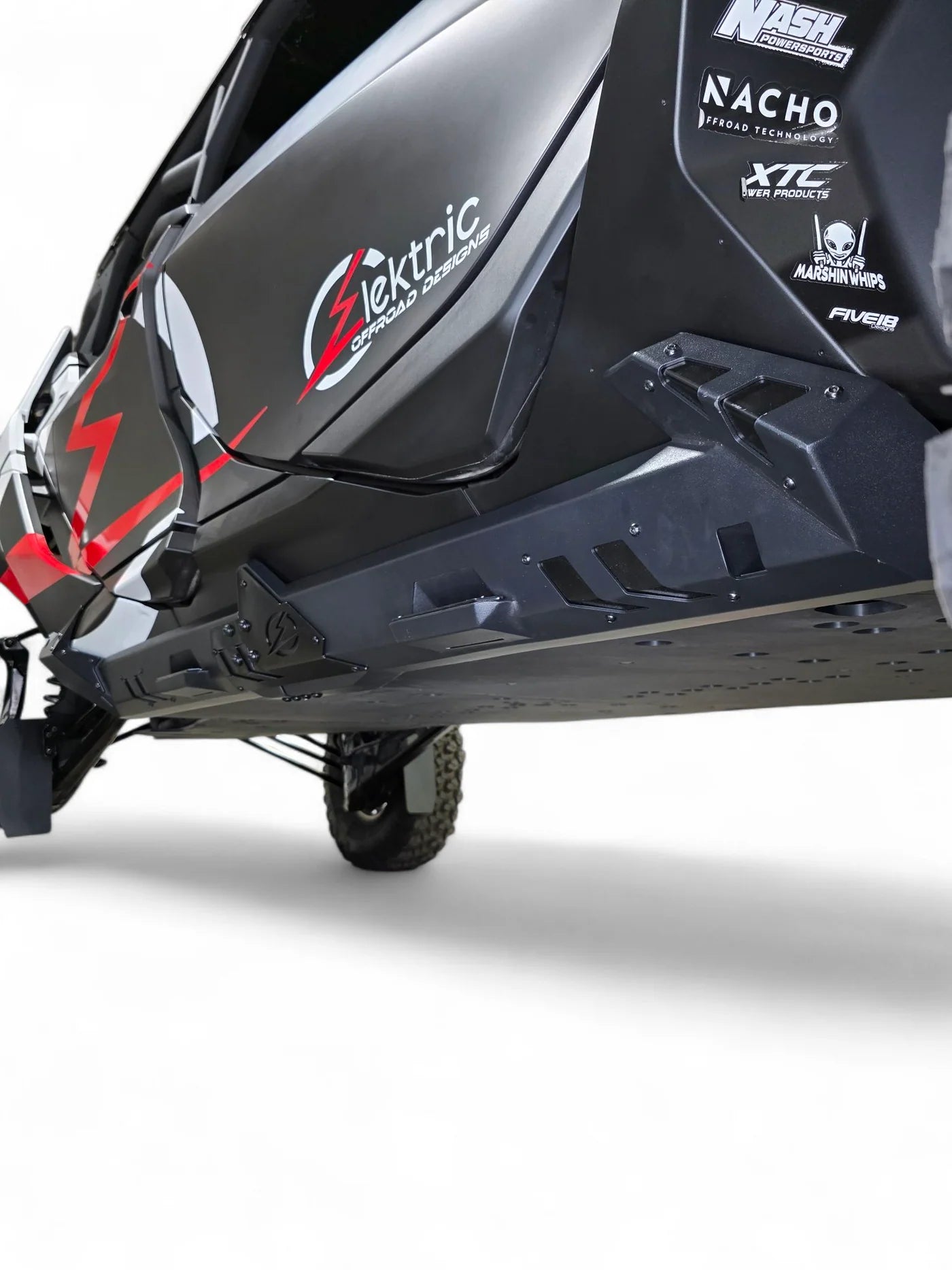 Close-up of a black electric vehicle with visible branding on a white background