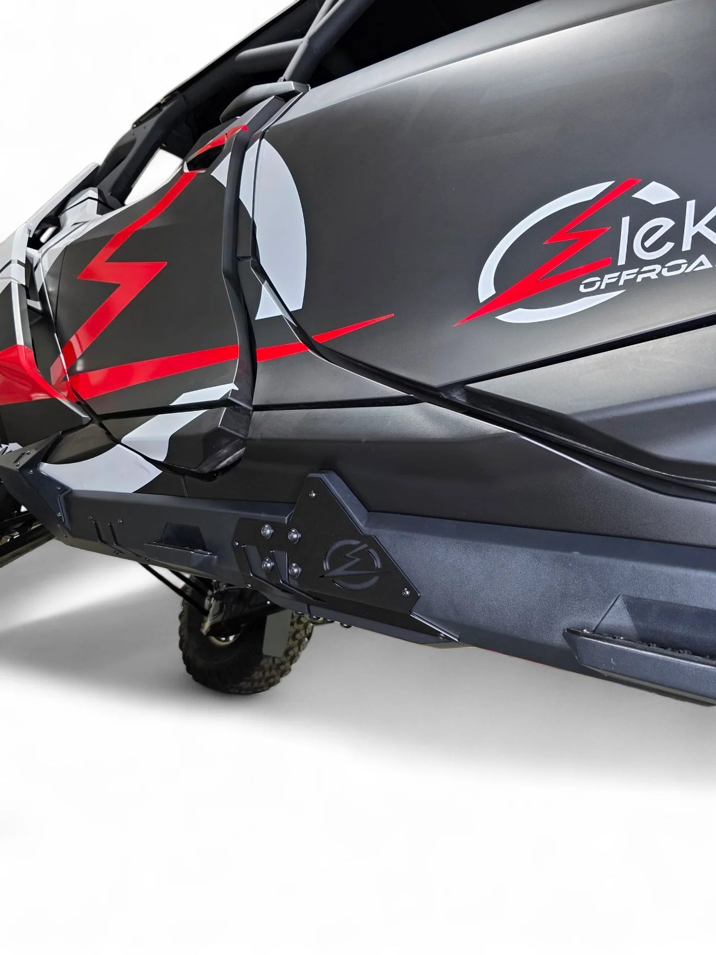 Close-up of a black off-road vehicle with red accents and 'Elek' branding on a white background.