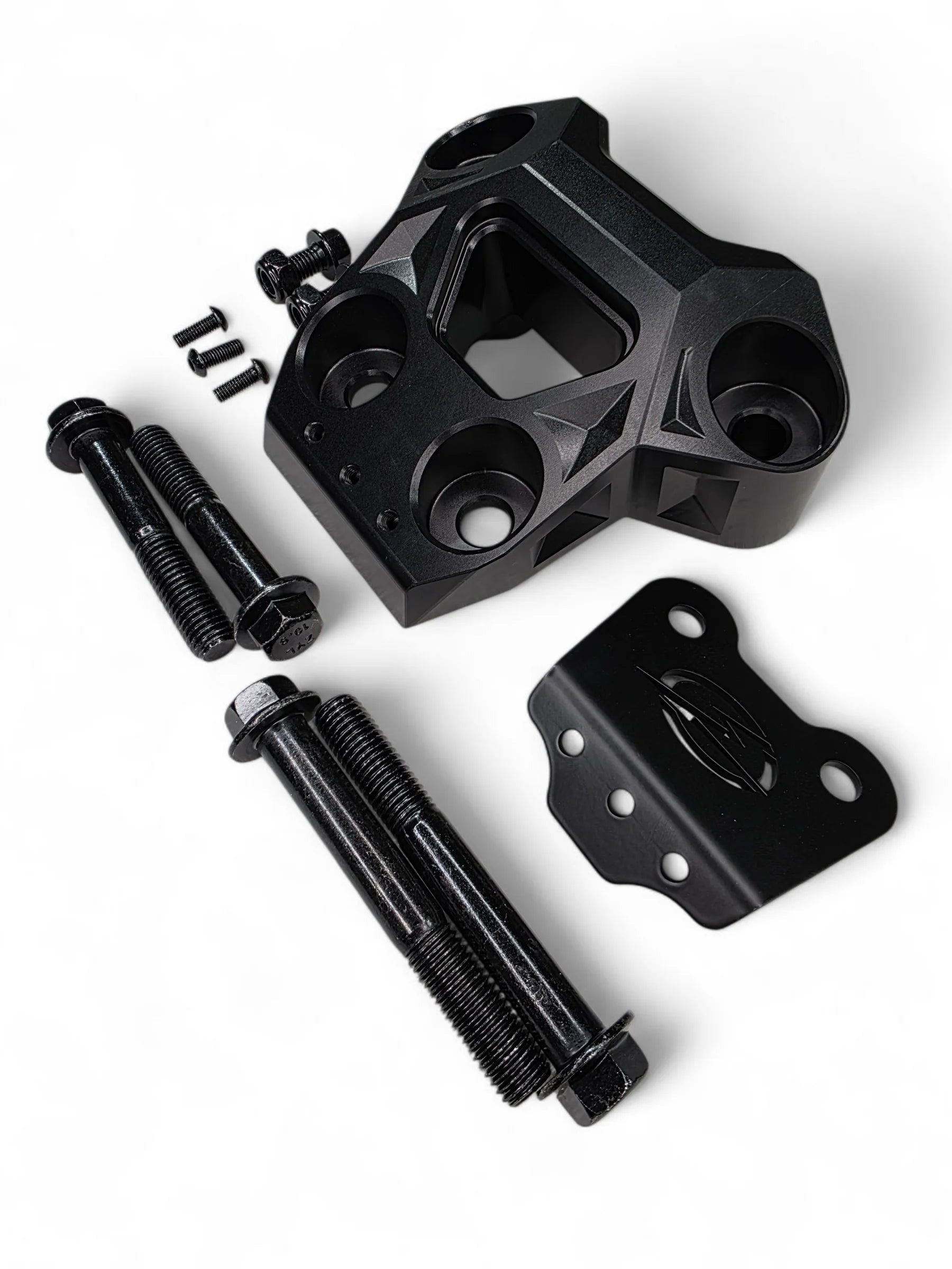 Black mechanical components including a large bracket, bolts, and a smaller metal piece on a white background.
