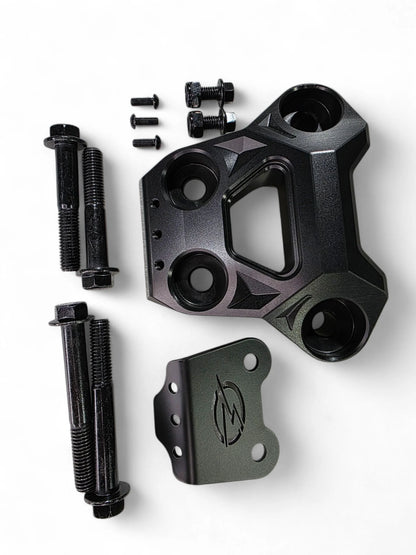 Black metal mechanical component with bolts on a white background