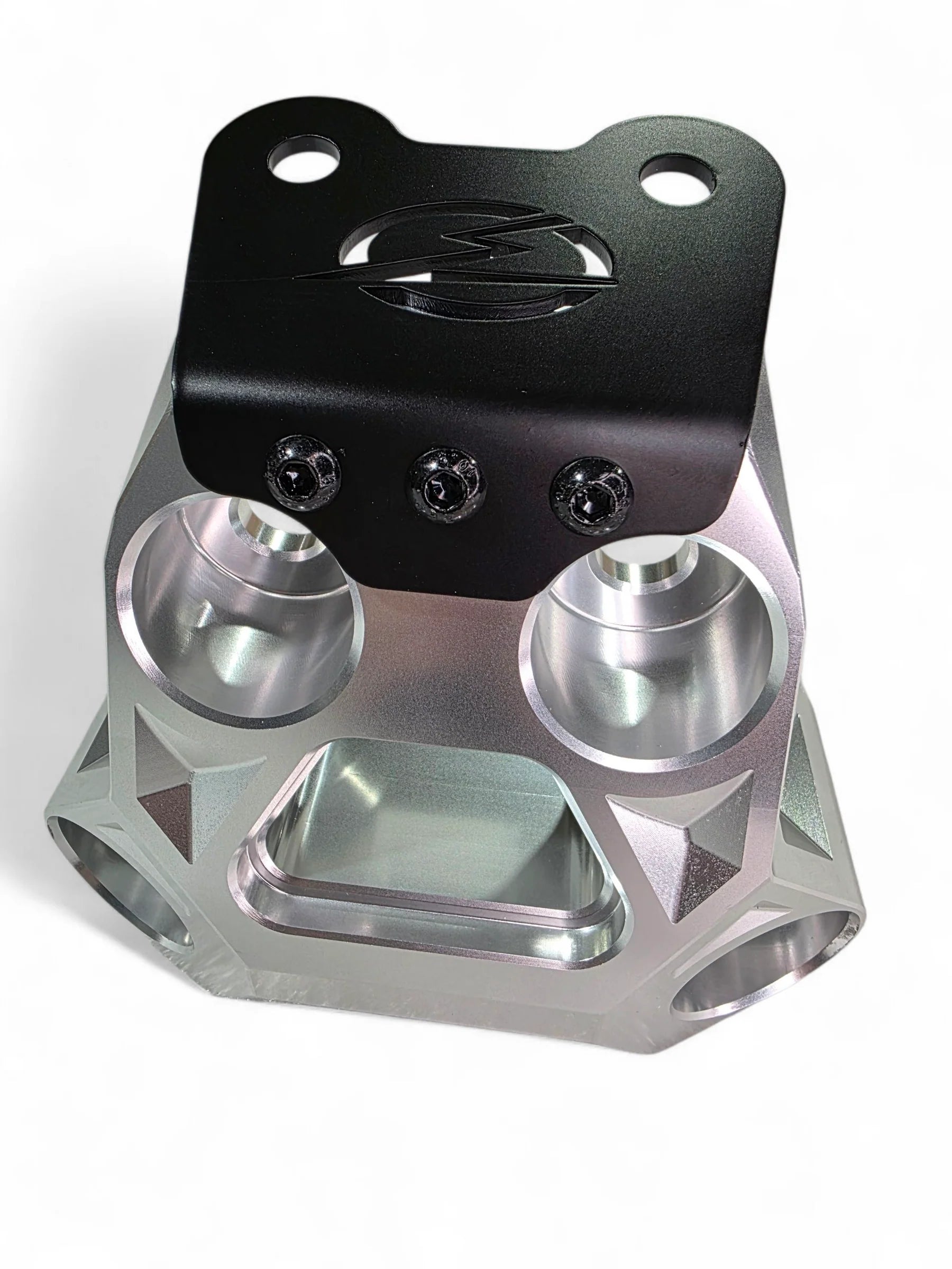 Metallic mechanical component with black top section on a white background