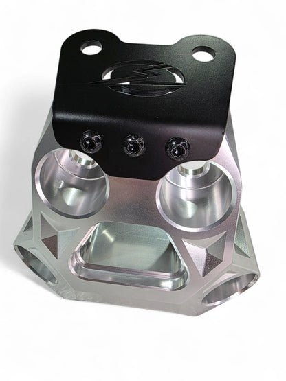 Metallic mechanical component with black top section on a white background