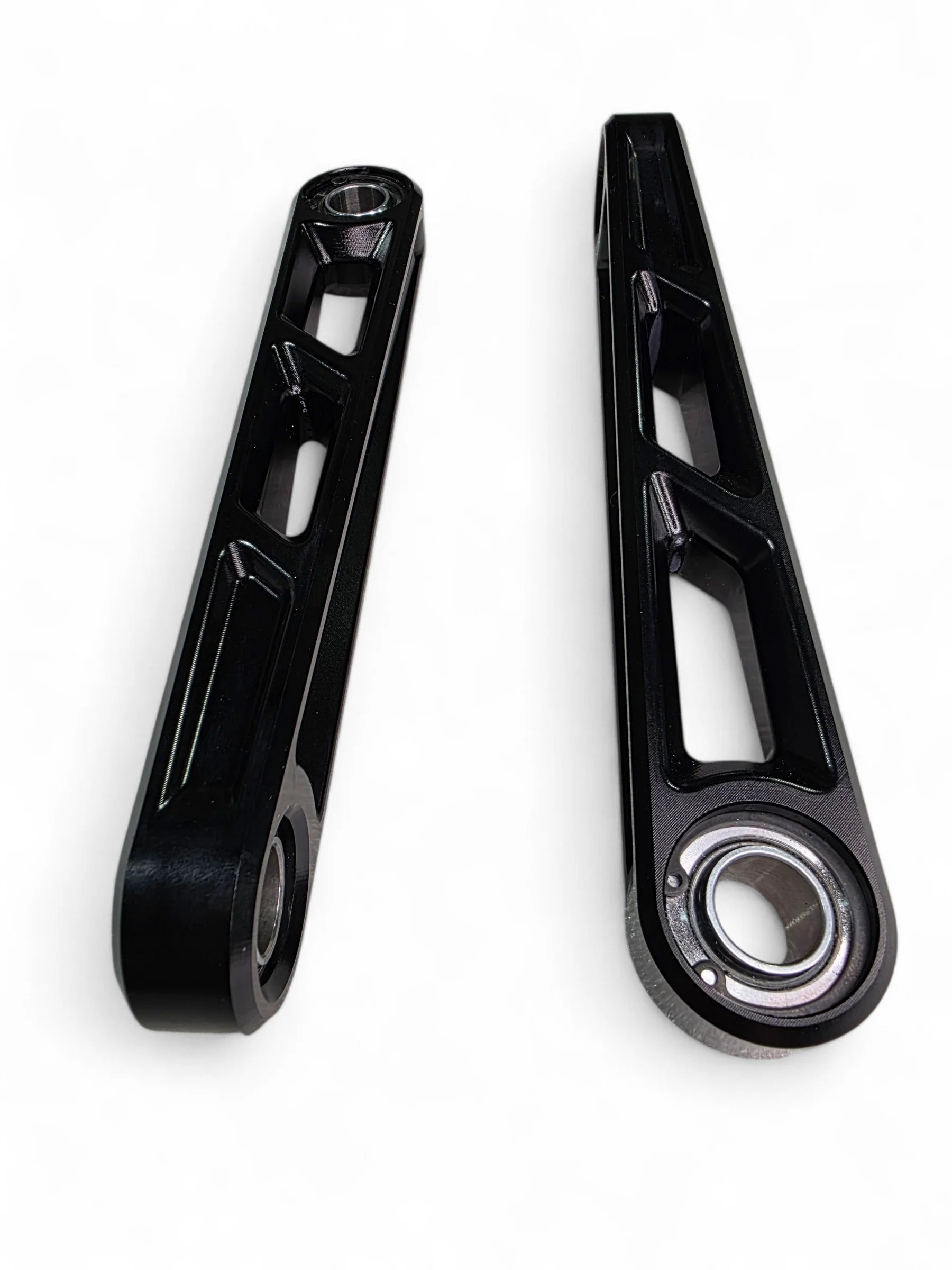 Two black metal connecting rods on a white background
