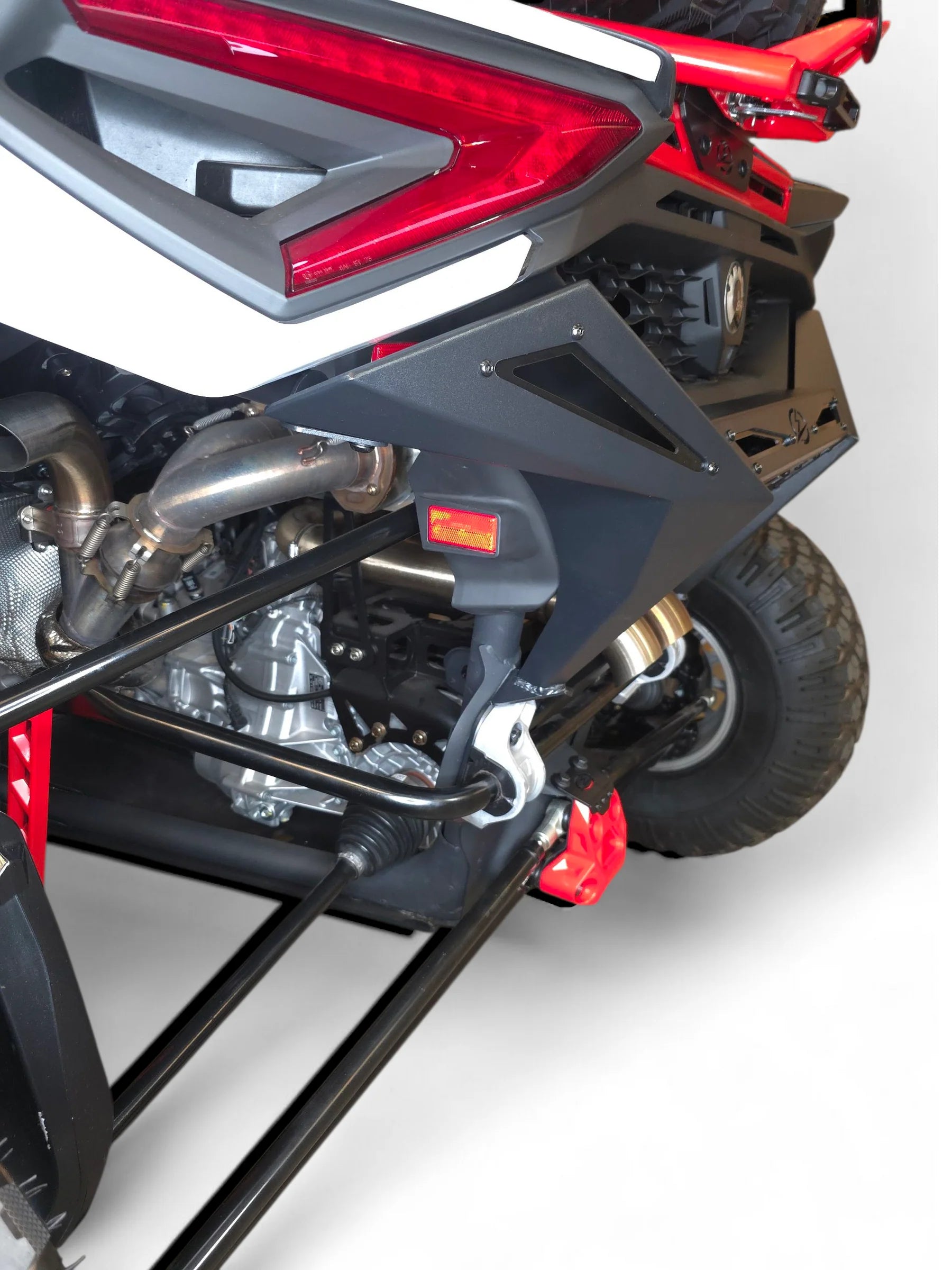 Close-up of a motorcycle's rear section with red and black design on a white background