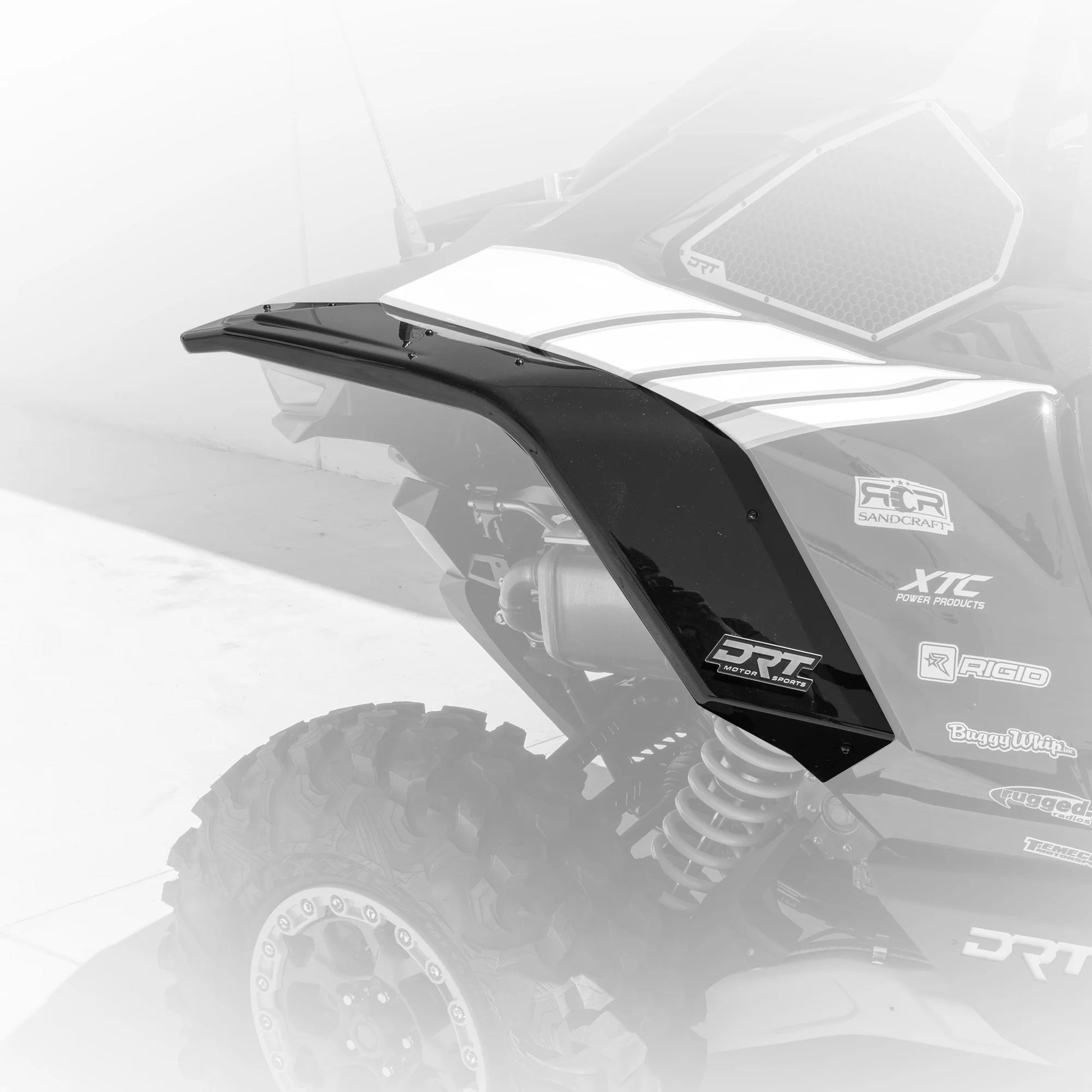 Black fender on an off-road vehicle with visible branding on a white background