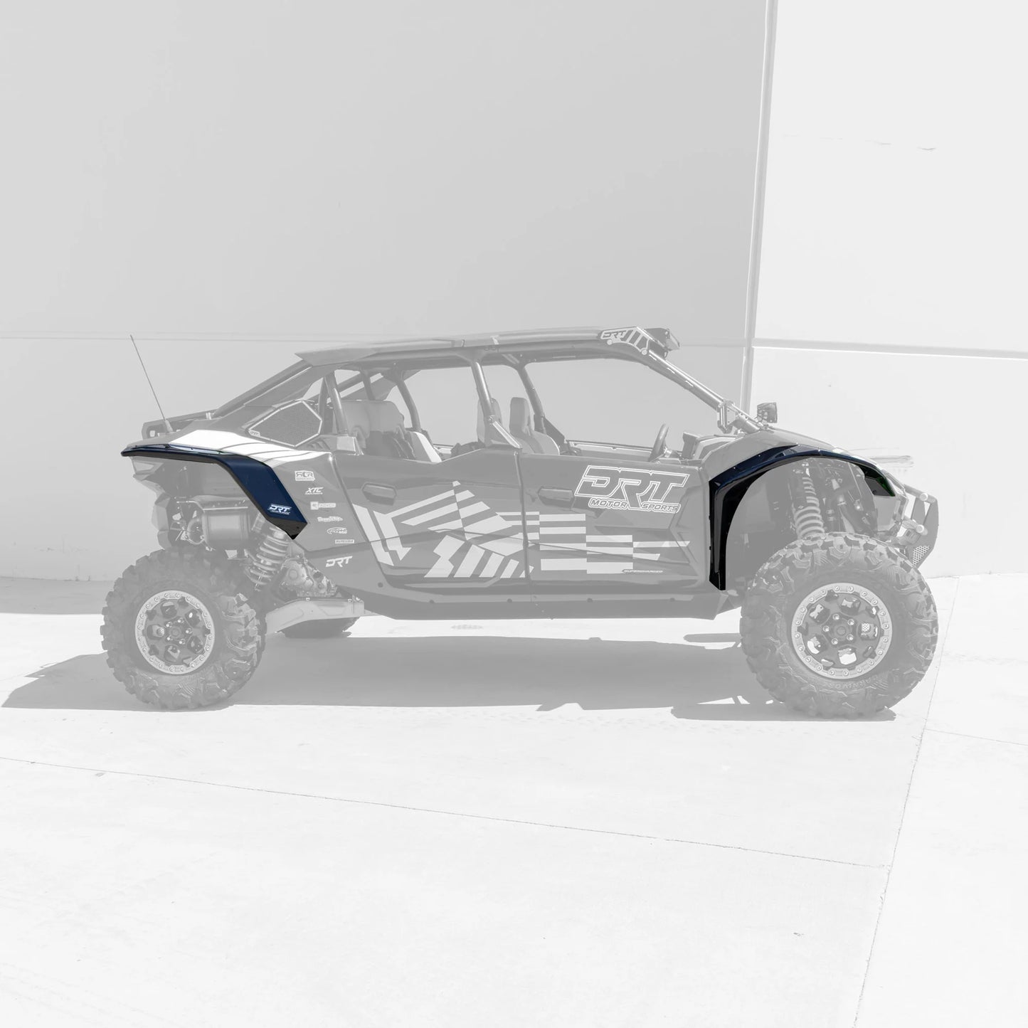 Side view of a off-road vehicle with 'DRT' branding on a white background