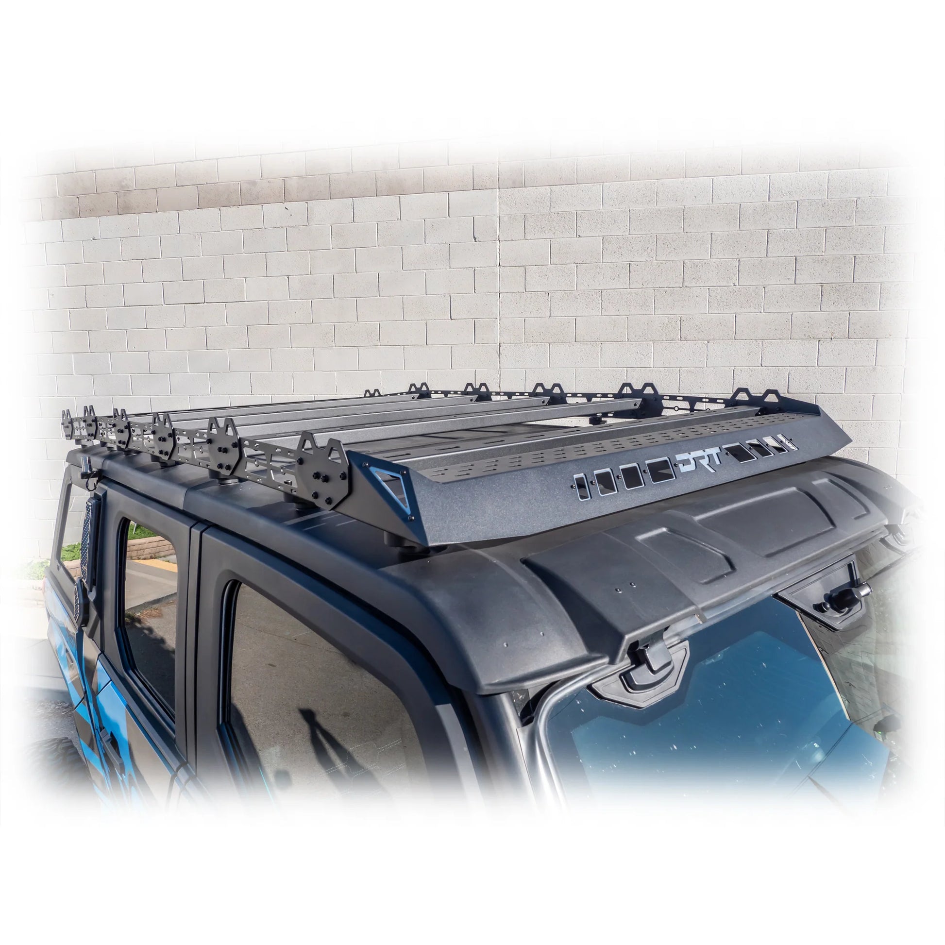 Car roof rack system on a vehicle with a white brick wall background