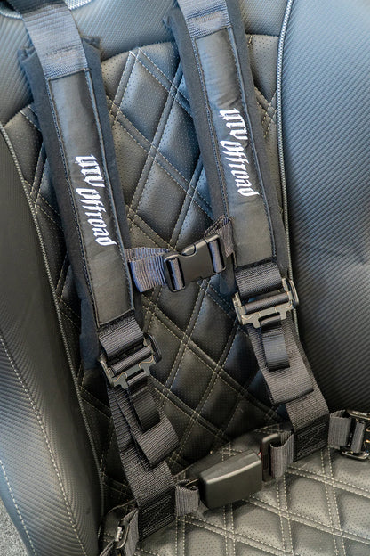 Gray harness seat belt system on a car seat with 'UW Offroad' branding.