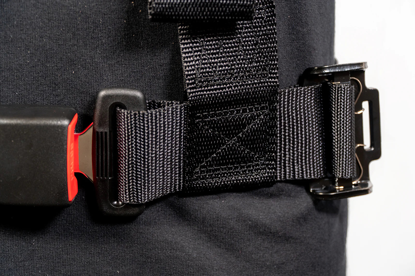 Close-up of a black backpack with a strap and buckle on a white background