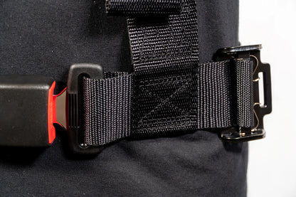 Close-up of a black backpack with a strap and buckle on a white background