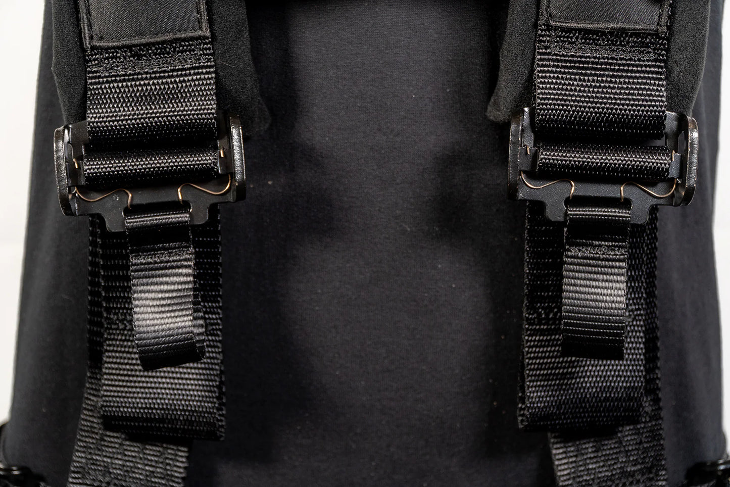 Close-up of black straps on a backpack with a blurred background