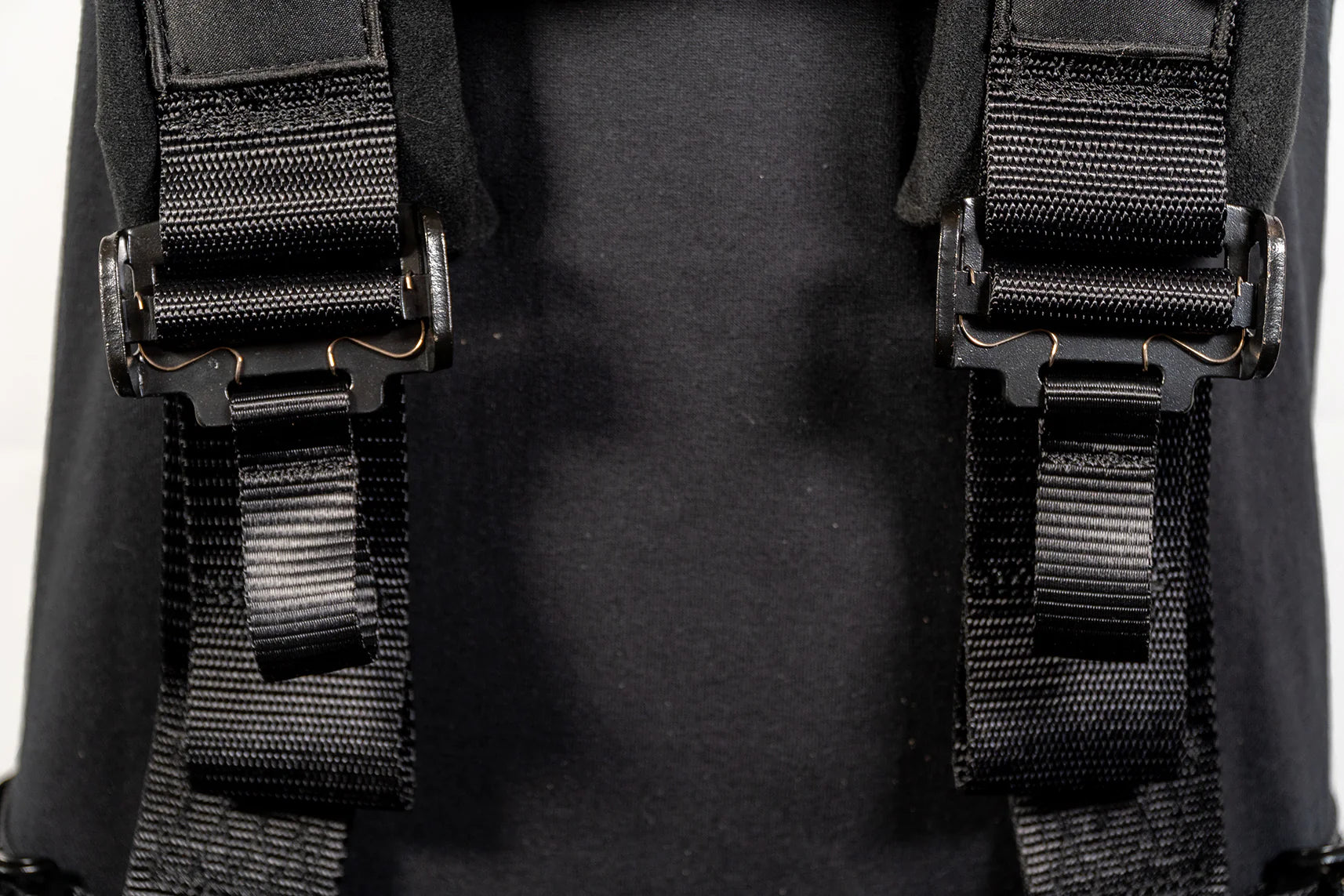 Close-up of black straps on a backpack with a blurred background