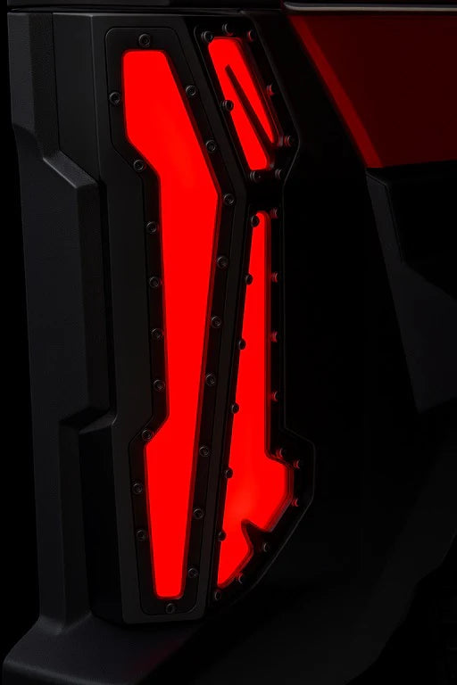 Close-up of a vehicle's red taillight with a black background